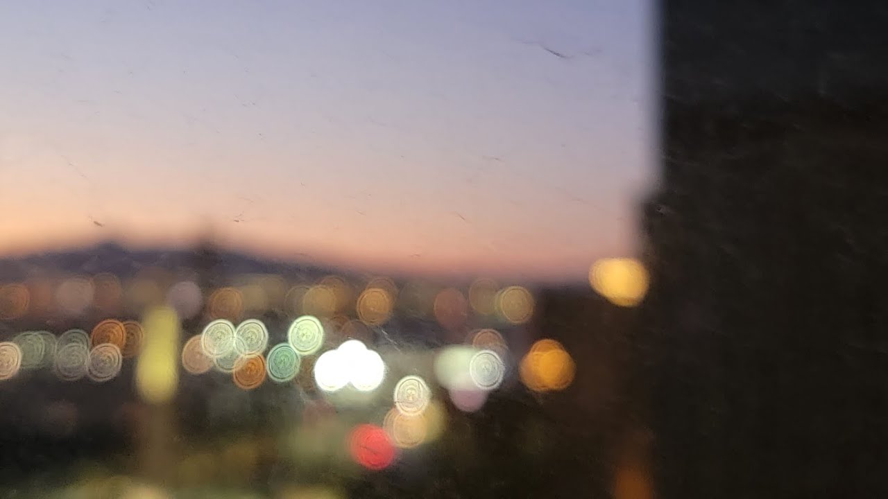 A city skyline at dusk seen through a window, from the documentary More than a Game